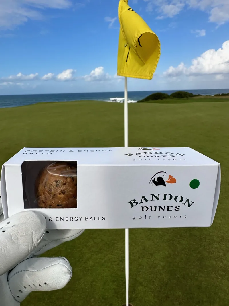 A flag and rolling fairway at a windswept destination course