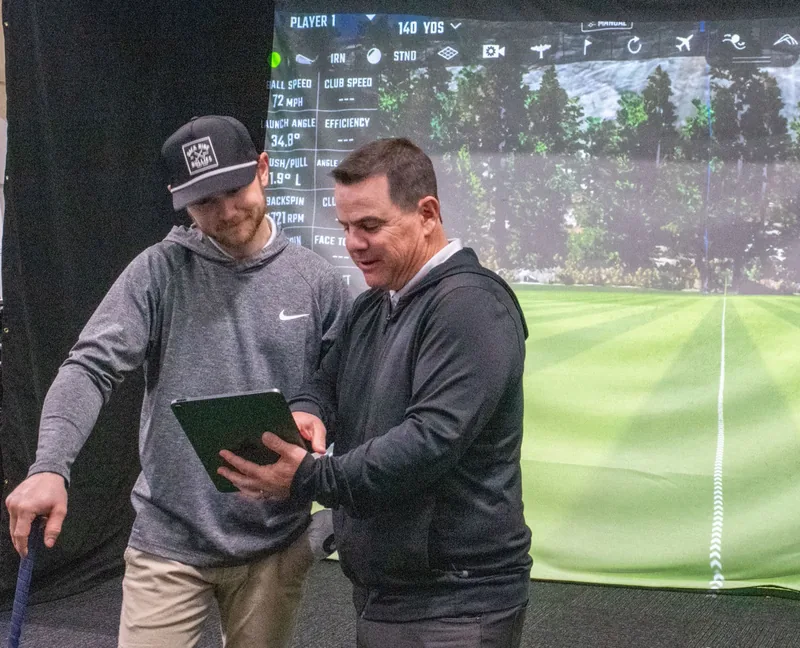 Chris Griffin reviews swing data with a golfer